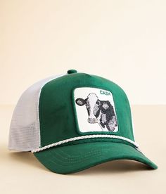 a green and white cap with a cow on it