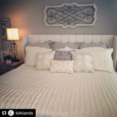 a large bed with white sheets and pillows