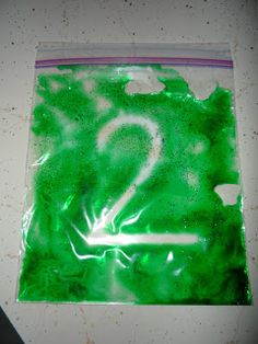 a green bag with the letter q painted on it