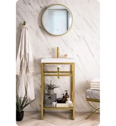 a bathroom with marble walls and gold fixtures