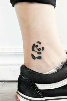 a small tattoo on the ankle of a woman's foot with a panda bear