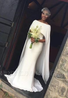 a woman in a white gown holding a bouquet