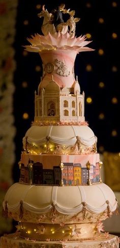 a wedding cake is decorated with pink and gold decorations