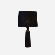 a black lamp with a dark shade on the top and bottom part of it's base