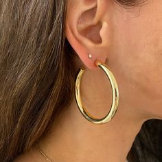 Large Gold Hoop Earrings These Large Hoop Earrings are a must-have in any jewelry collection. The classic hoop design is a best-seller, making it a versatile and timeless choice. These earrings are a basic staple that can elevate any outfit. Add these hoops to your accessory rotation and effortlessly enhance your style. Yellow Gold Plated 1.95" Diameter 0.20" Width Pierced Classic Round Hoop Earrings For Everyday, Timeless Luxury Small Hoop Earrings, Timeless Everyday Hoop Earrings, Classic Hoop Single Earring, Classic Small Hoop Earrings For Everyday, Classic Single Hoop Earring, Timeless Hypoallergenic Hoop Earrings, Classic Hoop Earrings For Everyday Luxury, Timeless Small Hoop Hypoallergenic Earrings