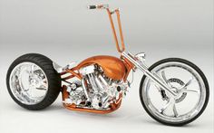 an orange motorcycle with chrome rims and wheels