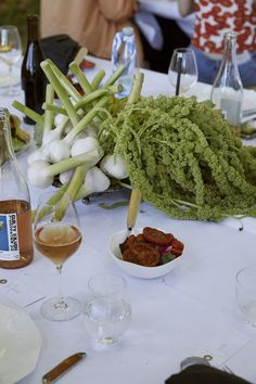 a table topped with lots of different types of food and wine glasses next to each other