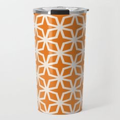 an orange and white pattern on a travel mug