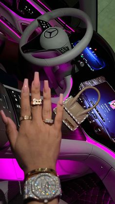 a woman's hand on the steering wheel of a car