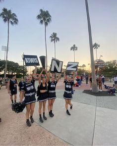 the cheerleaders are holding up their signs