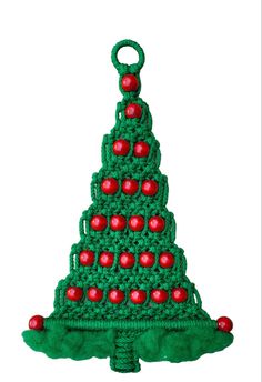 a crocheted christmas tree ornament with red balls