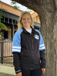 Head to the game in style with this Sporting Kansas City Black MVP 2.0 Track Jacket! Show off your Sporting KC pride in this Athletic Jacket, which features a embroidered felt logo at left chest. Go Sporting! Contrast color self fabric sleeve stripes, Zip Front closure, Welt pockets, Embroidered felt logo at left chest, Mitchell & Ness script embroidery on right cuff, Fit: Runs Small, 66% COTTON / 34% POLYESTER, Machine washable, 4 Sporty Long Sleeve Outerwear For Team Events, Sporty Long-sleeve Outerwear For Team Events, Sporty Winter Outerwear For Team Events, Urban Fitted Track Jacket For Sports, Sporty Fitted Track Jacket For College, Fitted Sporty Track Jacket For College, Script Embroidery, Sporting Kc, Embroidered Felt