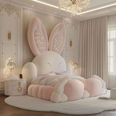 a white bed with pink pillows and bunny ears on it