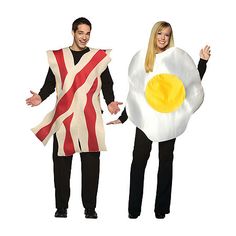 two people dressed in costumes holding an egg and bacon