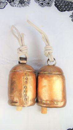 two old brass bells are tied up to each other