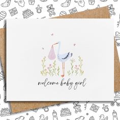 a card with a stork and flowers on it that says welcome baby girl