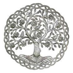 a metal tree with leaves and birds on it's branches is shown in the shape of a circle