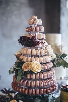 a tower of macaroons with flowers on top