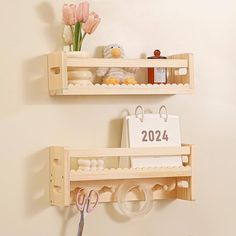 two wooden shelves holding items and scissors