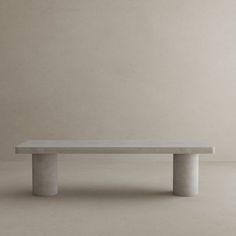 a concrete bench sitting on top of a white floor