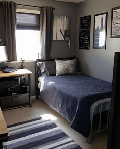 a bedroom with a bed, desk and pictures on the wall