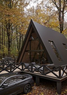 a - frame cabin in the woods with a hot tub and jacuzzi set up