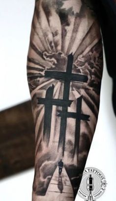 a person with a cross tattoo on their arm