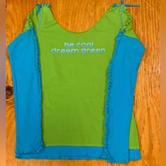 Funky Upcycled Long Sleeve T Shirt. Unknown Designer. Teal And Green Tee With Catchphrase ‘Be Cool Dream Green’ . Measurements In Photos. Equivalent To A Small, Imo. Never Been Worn. Green Y2k Stretch T-shirt, Sporty Blue Organic Cotton Tops, Spring Organic Cotton Stretch Tops, Green Graphic Print Cotton Tank Top, Green Cotton Graphic Print Tank Top, Relaxed Fit Blue Organic Cotton Tops, Blue Relaxed Fit Organic Cotton Tops, Green Stretch Cotton T-shirt, Green Cotton Y2k Tank Top