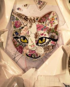 a close up of a cat made out of paper