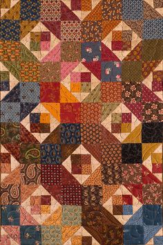 an old quilt with many different colors and patterns