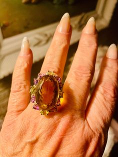 This is an authentic beautiful citrine peridot and amethyst ring. Size 9. The beautiful center stone is 35 ct citrine. It is surrounded by smaller peridot and amethyst. These beautiful gemstones are fashioned in a lovely sterling silver setting. This is a large statement ring. It is heirloom quality. Elegant Multicolor Amethyst Ring With Accent Stones, Multi-stone Citrine Gemstone Ring, Multi-stone Citrine Gemstones, Multicolor Elegant Amethyst Ring, Fine Jewelry Citrine Multi-stone Topaz Ring, Elegant Multi-stone Citrine Topaz Ring, Elegant Multi-stone Topaz And Citrine Ring, Luxury Green Amethyst Ring With Accent Stones, Luxury Green Amethyst Ring