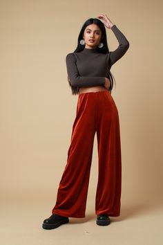 "PLEASE NOTE - Due to these trousers being handmade please allow 14-21 working days to be made and sent. The rust velvet trousers feature a soft 4 way stretch fabric complete an elasticated waistband and wide leg. Lightweight and versatile, perfect to pair with a cosy jumper for those spring walks or the black velvet halter for those festival adventures.. Trousers available in sizes 4,6,8,10,12,14,16,18,20: UK 4 - Waist 21\"- 22\", Hip 34\",  UK 6 - Waist 23\" - 24\", Hip 34\" UK 8 - Waist 25 \" Velvet Bottoms For Fall Loungewear, Fall Velvet Bottoms For Loungewear, Fall Velvet Loungewear Bottoms, Fall Velvet Wide Leg Straight Pants, Fall Velvet Trousers, Fall Velvet Wide Leg Pants, Stretch Velvet Pants For Loungewear, Stretch Velvet Lounge Pants, Cosy Jumper