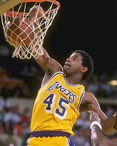 a basketball player is dunking the ball into the hoop with his hands in the air