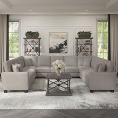 a living room filled with furniture and windows