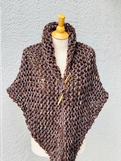 Hand knitted Outlander inspired shawl, scarf, shoulder wrap, neck warmer in marled brown with a hint of pale purple. - triangle design, can be worn in many different ways - one size fits all - made with 1 tassel, please let me know if you prefer 3 tassel (on each tip) or no tassels - super soft 50% acrylic, 30% wool, 20% mohair yarn - available in any color or yarn imaginable, please contact me for custom orders - made in smoke and pet free environment CARE: Hand wash , air dry. Handmade Yarn Shawl For Winter, Handmade Cozy Shawl For Fall, Hand Knitted Shawl Wrap For Fall, Handmade Cozy Shawl For Winter, Handmade Cozy Winter Shawl, Brown Crochet Shawl For Fall, Hand Knitted One Size Wraps For Fall, Handmade Brown Shawl For Fall, Brown Shawl Wrap One Size