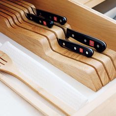 three knives are in a wooden holder