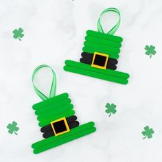 two st patrick's day decorations made out of popsicle sticks and green ribbon