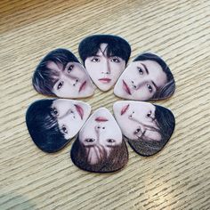 the beatles guitar pickers are arranged in a circle on top of a wooden table