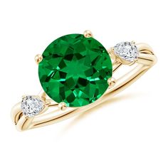 a green ring with two diamonds on the band and an oval cut emerald stone in the center