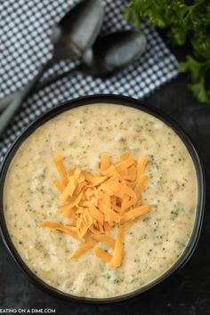 a black bowl filled with cheese on top of a table