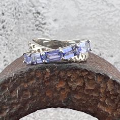 Lovely EFFY Tanzanite Gemstones set in a 925 Sterling Silver Crossover Ring US Size 7 Tanzanite 1.52 ctw, approximately. Widest point measures approximately 7 mm. Back of the shank tapers down to approximately 3.8 mm. Weighs approximately 4 grams. Stamped EFFY 925 MSRP $624 Effy Tanzanite Rings, Crossover Ring, Tanzanite Gemstone, Multi Stone Ring, Multi Stone, Stone Rings, Crossover, Jewelry Rings, Accessory Gift