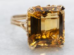 Transform your look with solitaire ring. The stunning emerald cut citrine stone set in yellow gold adds a touch of elegance and sophistication to any outfit. A perfect statement piece for any occasion.Metal: 14K Yellow GoldGem: Citrine 9.11 CaratsGem Measurements: 11.8 x 13.1 mm, Emerald CutRing Size: 6.25Marks: "14K" Stamped on the inside band Elegant Yellow Gold Emerald-cut Topaz Ring, Elegant Emerald Cut Yellow Gold Topaz Ring, Elegant Yellow Gold Emerald Cut Topaz Ring, Yellow Gold Citrine Topaz Ring, Emerald Cut, Formal Solitaire Topaz Ring, Rectangular Yellow Gold Topaz Ring, Elegant Yellow Gold Rectangular Topaz Ring, Yellow Emerald-cut Topaz Ring, Gold Emerald Cut Topaz Ring