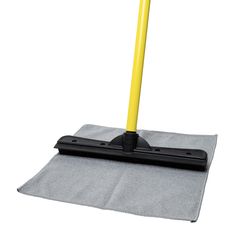 a dust mop on top of a gray towel with a yellow handle and black base