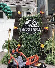 a ride on the back of a toy car in front of a sign that says grevoiu's world