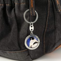 a close up of a bag with a key chain on it's front pocket