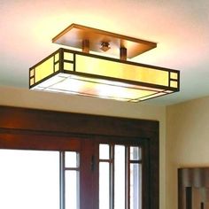 a light that is on in the ceiling above a door with glass doors and windows