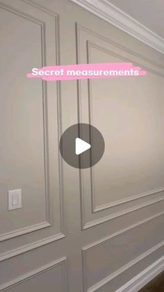 an empty room with the words secret measurements on it's wall and a video player playing