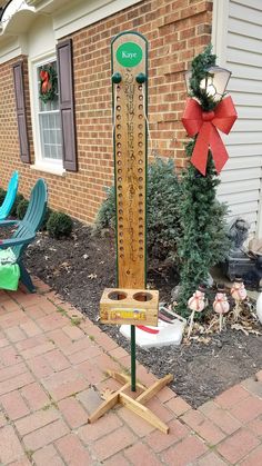 a wooden pole with a sign on it in front of a brick building and lawn chairs