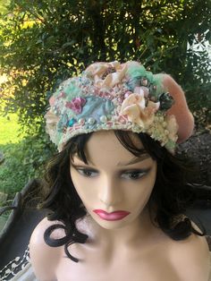 a mannequin wearing a hat with flowers on it