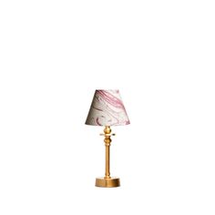 a lamp with a pink and white marble shade on the base, sitting against a white background